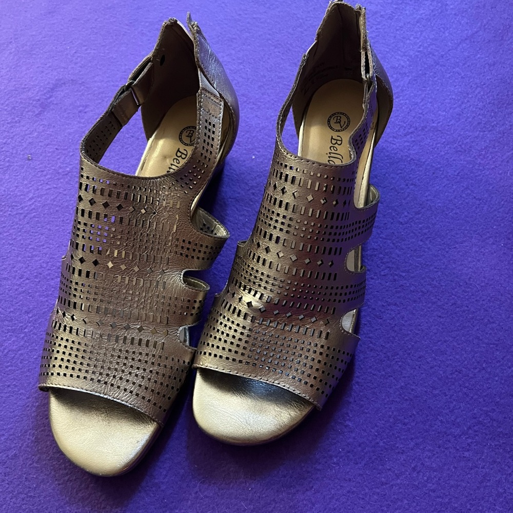 Gold sandals with small wedge heel.  Zips in back.  Size 8.5